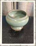 Vintage Frankoma Prairie Green footed bowl with smooth celadon glaze on dark wood surface