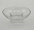 Modern clear glass bowl with thick square base and wide flared rim on white background